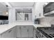 Stylish kitchen features white countertops, modern appliances, gray cabinets, and an open layout for easy socializing at 5421 Gay St, Weeki Wachee, FL 34607