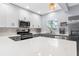 Spacious kitchen with quartz countertops, stainless steel appliances, and two-tone cabinets at 5421 Gay St, Weeki Wachee, FL 34607