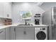 Modern kitchen with new stainless steel refrigerator and appliances, along with contemporary countertops and cabinetry at 5421 Gay St, Weeki Wachee, FL 34607