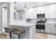 Modern kitchen with white cabinets, stainless steel appliances, and breakfast bar seating at 5421 Gay St, Weeki Wachee, FL 34607
