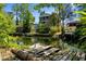Waterfront property featuring a canal with a weathered dock, mature trees, and a view of the multi-story home at 5421 Gay St, Weeki Wachee, FL 34607