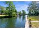 Scenic waterfront property with lush landscaping and a private dock on a canal at 5421 Gay St, Weeki Wachee, FL 34607