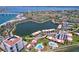 Scenic aerial shot featuring the residential area, lake, swimming pools and manicured lawns at 6290 Bahia Del Mar Cir # 12, St Petersburg, FL 33715