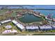 Stunning aerial view of waterfront community boasting lush landscaping, sparkling pool, and picturesque lake views at 6290 Bahia Del Mar Cir # 12, St Petersburg, FL 33715