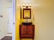 Stylish powder room boasts a vessel sink and wood cabinet at 6290 Bahia Del Mar Cir # 12, St Petersburg, FL 33715
