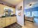 Bathroom featuring a vanity with black countertop and a glimpse of the bedroom with blue walls at 6290 Bahia Del Mar Cir # 12, St Petersburg, FL 33715