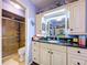 Stylish bathroom with bright lighting, shower and a vanity with marble countertop at 6290 Bahia Del Mar Cir # 12, St Petersburg, FL 33715