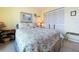 Cozy bedroom with queen bed, floral comforter, and ample natural light at 6290 Bahia Del Mar Cir # 12, St Petersburg, FL 33715