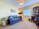 Bedroom featuring neutral carpet, sofa, window with blinds, and decorative furnishings at 6290 Bahia Del Mar Cir # 12, St Petersburg, FL 33715