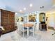 Dining room adjacent to kitchen features updated lighting and a neutral color palette at 6290 Bahia Del Mar Cir # 12, St Petersburg, FL 33715