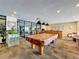 Well-lit game room with a pool table, bar, and fitness area featuring modern equipment at 6290 Bahia Del Mar Cir # 12, St Petersburg, FL 33715