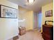 Upstairs hallway showing artwork, neutral walls, carpet, and a wooden chest at 6290 Bahia Del Mar Cir # 12, St Petersburg, FL 33715