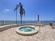 Inviting outdoor jacuzzi with surrounding brick pavers and scenic waterfront backdrop at 6290 Bahia Del Mar Cir # 12, St Petersburg, FL 33715