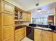 The kitchen boasts wood cabinetry, stone countertops, and a functional breakfast bar overlooking the living area at 6290 Bahia Del Mar Cir # 12, St Petersburg, FL 33715