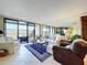 Bright living room featuring large sliding glass doors leading to a private balcony with serene water views at 6290 Bahia Del Mar Cir # 12, St Petersburg, FL 33715