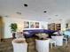 Well-lit lounge area featuring a large sectional couch, comfortable chairs, and a bookcase at 6290 Bahia Del Mar Cir # 12, St Petersburg, FL 33715