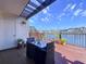 Charming outdoor patio with a black table, chairs, and a view of the water and blue sky at 6290 Bahia Del Mar Cir # 12, St Petersburg, FL 33715