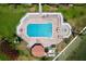 Aerial view of community pool with hot tub and ample lounge seating overlooking a serene body of water at 6290 Bahia Del Mar Cir # 12, St Petersburg, FL 33715