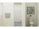 Clean bathroom showing a toilet, open doorway to shower, and fresh neutral tones throughout at 6905 E 116Th Ct, Palmetto, FL 34221