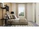 Stylishly furnished bedroom showcasing a comfortable bed, modern desk, and natural light from the window at 6905 E 116Th Ct, Palmetto, FL 34221