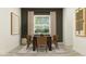 Inviting dining room with seating for six, complemented by modern decor and natural light from the window at 6905 E 116Th Ct, Palmetto, FL 34221