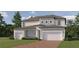 Charming two-story home featuring a two-car garage, landscaped yard, and neutral color palette at 6905 E 116Th Ct, Palmetto, FL 34221