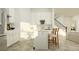 Well-lit eat-in kitchen featuring white cabinets, a stainless steel fridge, and a view of the staircase at 6905 E 116Th Ct, Palmetto, FL 34221