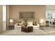 Warm, inviting living room featuring a comfortable sofa, stylish lamps, and a view into the kitchen at 6905 E 116Th Ct, Palmetto, FL 34221