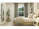 Pleasant bedroom featuring a bed, a full length mirror, a potted tree, and a large window at 6909 E 116Th Ct, Palmetto, FL 34221