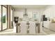 Open-concept dining room leading to a modern kitchen, features a table with seating for six at 6909 E 116Th Ct, Palmetto, FL 34221