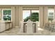 Bright dining room with large windows, a rectangular table set for six, with views to the backyard at 6909 E 116Th Ct, Palmetto, FL 34221