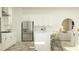 A modern kitchen showcases white cabinets, stainless steel appliances, and a large island with seating at 6909 E 116Th Ct, Palmetto, FL 34221