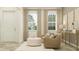 Bright living room featuring tan armchairs, neutral decor and two windows for ample natural light at 6909 E 116Th Ct, Palmetto, FL 34221