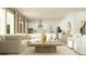 Open-concept floor plan featuring living room with large sofa and connected kitchen with stainless appliances at 6909 E 116Th Ct, Palmetto, FL 34221