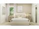 Bright bedroom featuring neutral tones, framed artwork, bedside tables with lamps, plush bedding, and a closet at 6909 E 116Th Ct, Palmetto, FL 34221