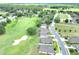 Scenic aerial view of homes along a golf course in a lush, green community, promoting an active lifestyle at 7099 Crested Orchid Dr, Brooksville, FL 34602