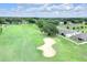 Scenic aerial view of a home backing onto a golf course surrounded by lush greenery at 7099 Crested Orchid Dr, Brooksville, FL 34602