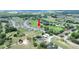 Aerial view showing the location of the property in the neighborhood, close to a golf course at 7099 Crested Orchid Dr, Brooksville, FL 34602