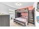 ' bedroom with a bunk bed and closet space, carpet flooring, and neutral paint at 7099 Crested Orchid Dr, Brooksville, FL 34602