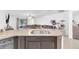 Modern kitchen with granite countertops and views into the living area with access to the patio at 7099 Crested Orchid Dr, Brooksville, FL 34602