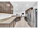 Spacious kitchen with granite countertops, stainless steel appliances, and tile flooring at 7099 Crested Orchid Dr, Brooksville, FL 34602