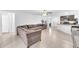 Open concept living room with neutral paint, and tiled floors, flowing into the kitchen at 7099 Crested Orchid Dr, Brooksville, FL 34602