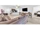 Open concept living room with neutral paint, and tiled floors, flowing into the kitchen at 7099 Crested Orchid Dr, Brooksville, FL 34602