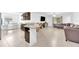 Open-concept living space with modern kitchen, dining area, and cozy living room with tile floors at 7099 Crested Orchid Dr, Brooksville, FL 34602