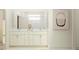 Bright bathroom with a double vanity, large mirror, and modern shower fixtures at 7524 E 116Th St, Palmetto, FL 34221