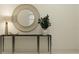 Modern hallway featuring a round mirror, dark console table and a potted plant for added freshness at 7524 E 116Th St, Palmetto, FL 34221