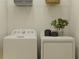 Bright laundry room featuring white appliances and a wire shelf for efficient storage at 7524 E 116Th St, Palmetto, FL 34221