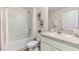 Bathroom with tiled tub and shower combo, neutral color palette, and granite countertop at 803 Ace Outlaw Pl, Ruskin, FL 33570