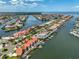 Aerial view showcases home's prime waterfront location with canal access, boat docks, and coastal charm at 813 Symphony Isles Blvd, Apollo Beach, FL 33572