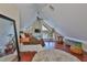 Charming bedroom with angled ceilings, wood floors, unique windows, and comfortable furnishings at 813 Symphony Isles Blvd, Apollo Beach, FL 33572